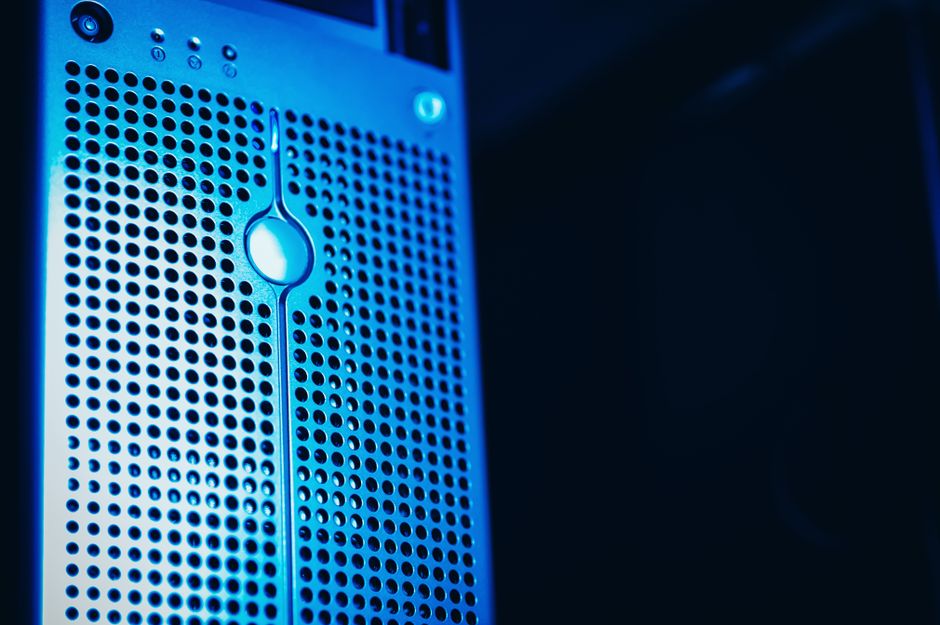 A clean shot of a data center server rack with many blinking lights and cables, representing internet infrastructure.